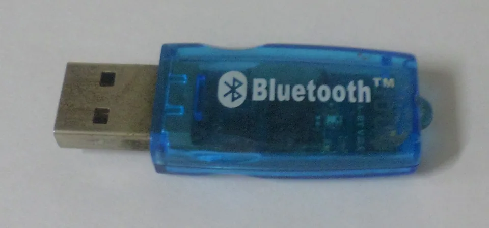 Blue translucent USB Bluetooth adapter on a pale background