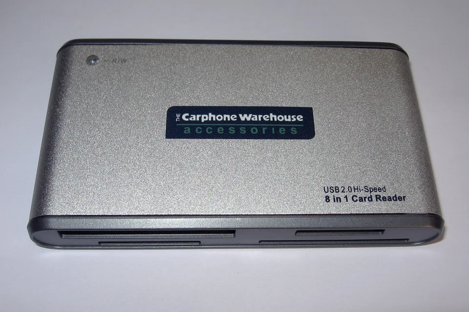 Silver external 8-in-1 USB memory card reader with card slots along its front edge