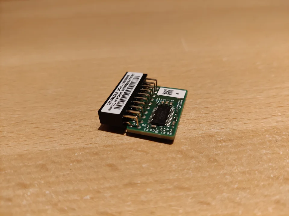 Supermicro AOM-TPM-9665V-S TPM 2.0 add-on module on a wooden surface