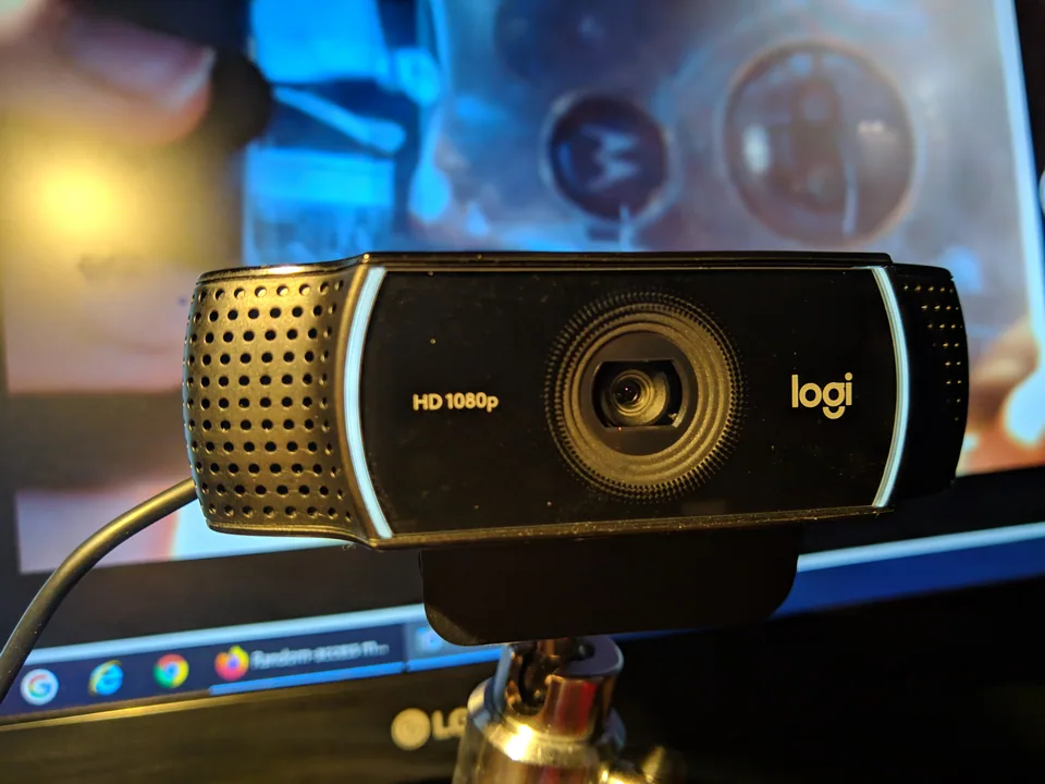 Black Logitech C922 webcam mounted in front of a computer display